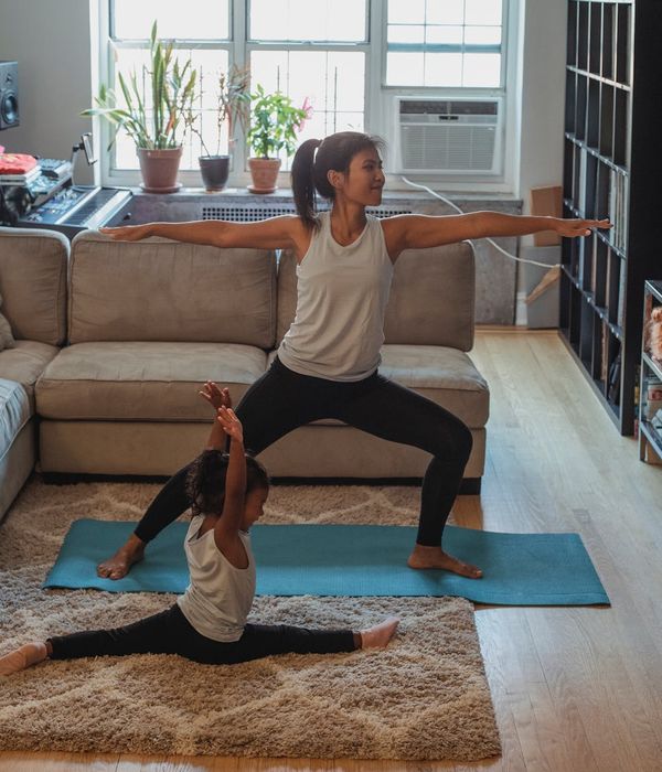 Woman performing a balanced yoga pose in a dark room